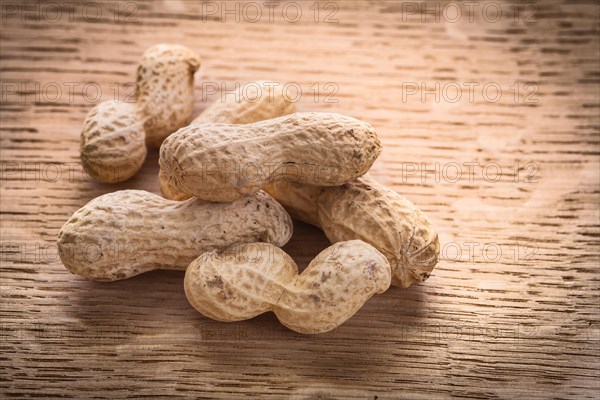 Small pile of peanuts on wooden board Food and drink concept