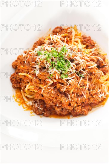 Italian classic spaghetti with bolognese sauce and fresh vegetables on background