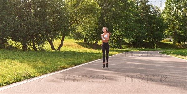 Sports girl jogging in the park. The concept of a healthy lifestyle. Sports Equipment. Fitness style advertisement. mixed media