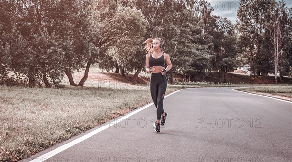 Sports girl jogging in the park. The concept of a healthy lifestyle. Sports Equipment. Fitness style advertisement. mixed media