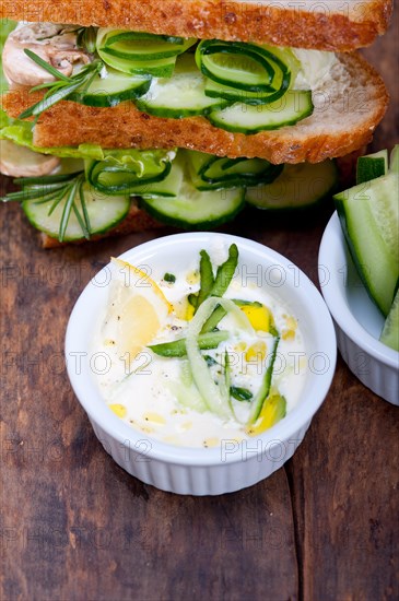 Fresh vegetarian sandwich with garlic cheese dip salad on rustic table