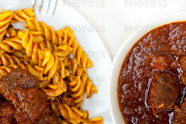 Fusilli pasta al dente with neapolitan style ragu meat sauce very different from bolognese style