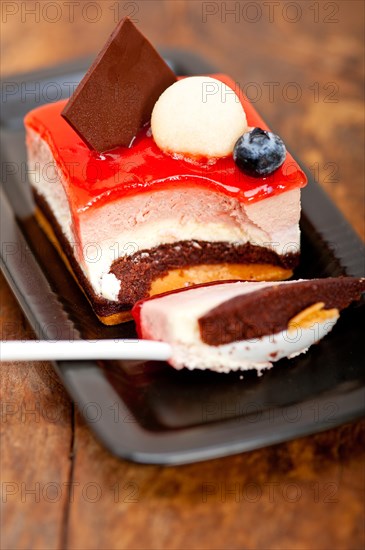 Fresh strawberry yogurt mousse with macaroon and blueberry on top