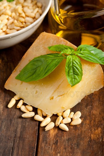 Italian basil pesto ingredients over old wood macro