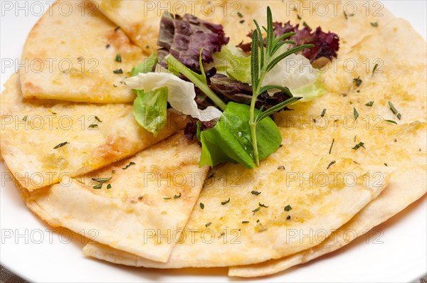 Fresh healthy garlic pita bread pizza with salad on top
