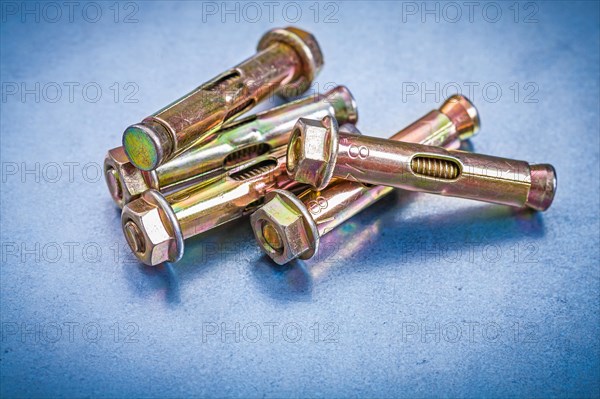 Set of metal anchor bolts for concrete walls on metallic background Construction concept