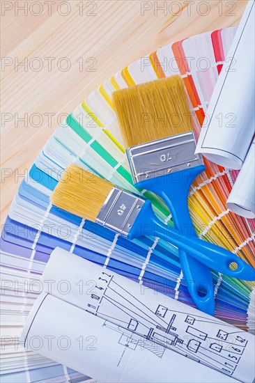 Blue prints and paintbrushes on opened colour palette