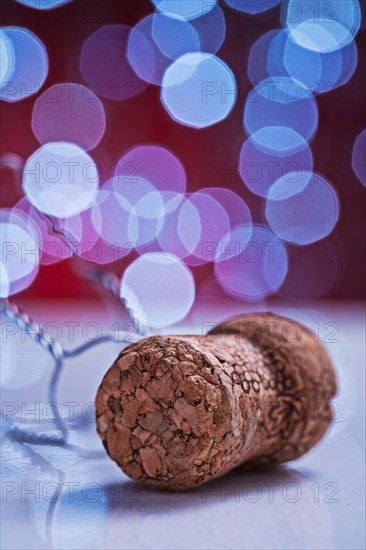 Champagne cork on white table and blurred background with bokeh