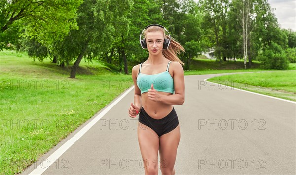 Sports girl jogging in the park. The concept of a healthy lifestyle. Sports Equipment. Fitness style advertisement. Mixed media