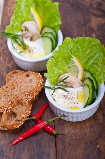 Fresh organic garlic cheese dip salad on a rustic table with bread