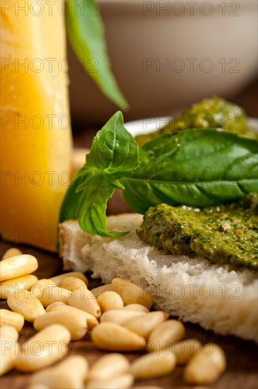 Italian basil pesto bruschetta ingredients over old wood macro