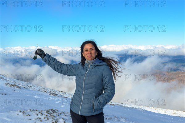 Portrait of latin woman smiling in the snow