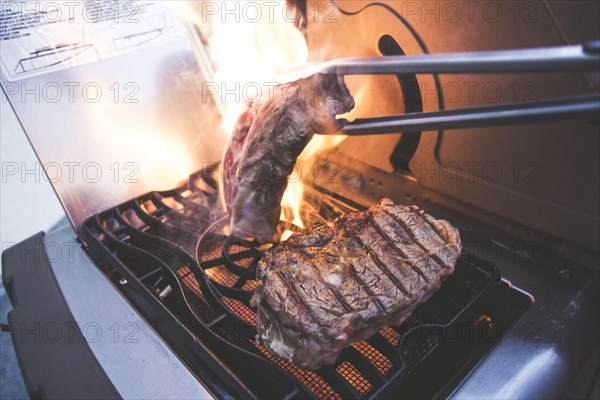 A steak on a gas barbecue in the fire
