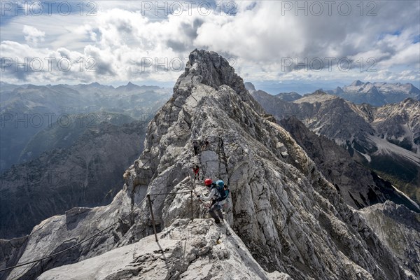 Climber on a via ferrata secured with steel rope