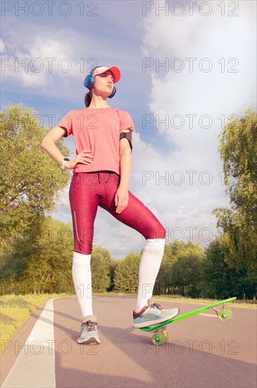 Image of a girl riding a skateboard in the park. Sports concept.