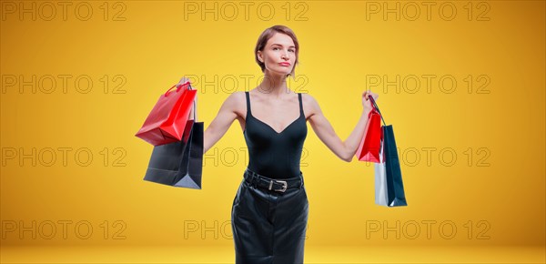 Business woman posing in studio with packages with gifts. International women's day concept. Valentine's Day.