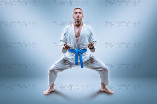 Professional wrestler is wearing a kimono. He is preparing to demonstrate the kata. The concept of mixed martial arts