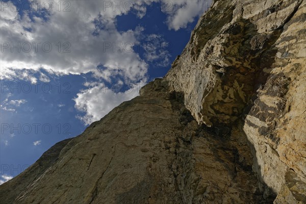 Striking limestone rock formation Burgstein with blue and white sky in the upper Altmuehltal surrounded by green vegetation