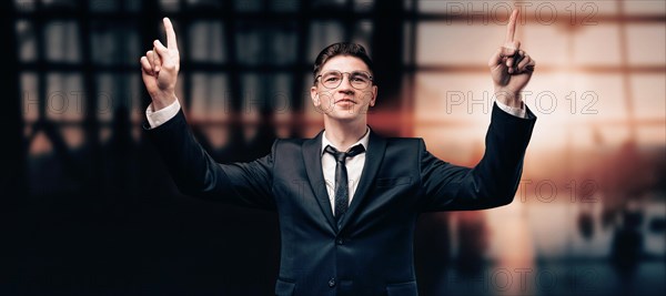 Portrait of a man in a business suit. He is standing at the airport with his hands up. VIP transportation. Private airlines. Charter flights.