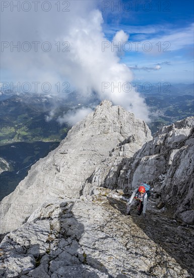Climber on a via ferrata secured with steel rope