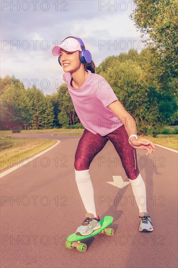 Image of a girl riding a skateboard in the park. Sports concept.