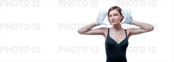 Surprised beautiful young woman in white gloves posing in the studio on a white background.