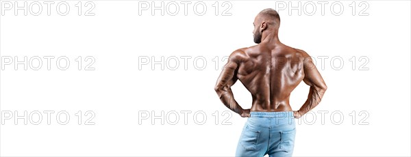 Sportsman posing on a white background in jeans. Back view. Fitness