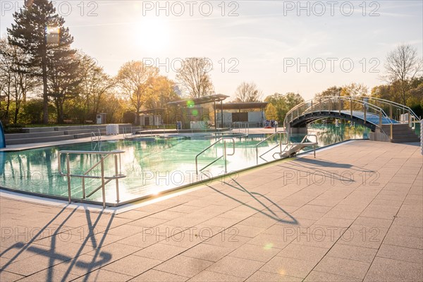 Long shadows and sparkling water in a swimming pool during a sunset