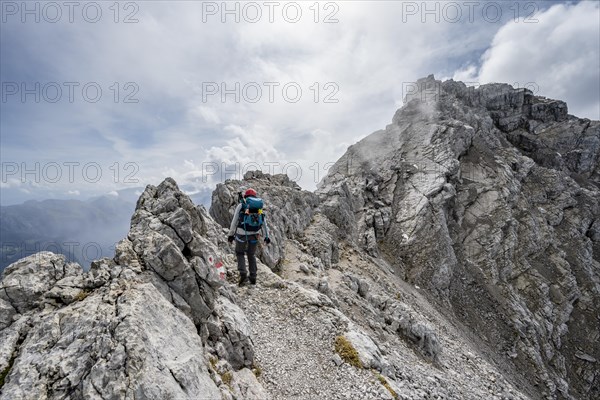 Mountaineer on a narrow rocky ridge