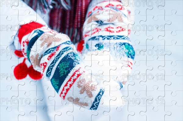 Image of a snowball in Christmas mittens. Puzzle. Jigsaw. Concept for Christmas holidays and gifts.