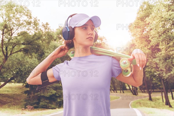 Portrait of a teenage girl with a skateboard. Sports lifestyle concept.