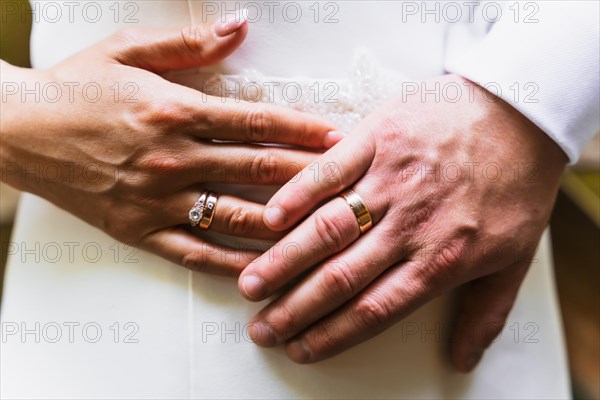 Detail of hands of bride and groom with rings at a wedding