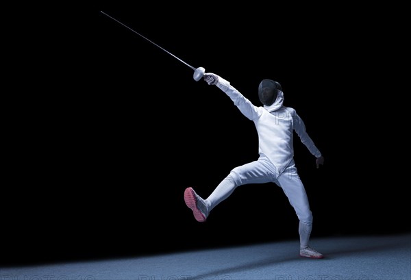 The fencer moves forward with a sword in his hand. Sport concept.