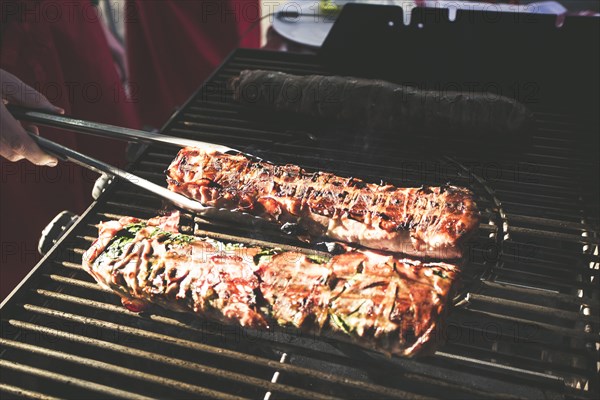 A piece of meat on a gas barbecue