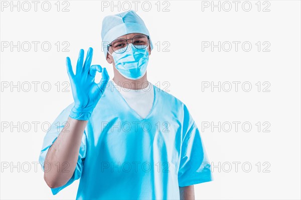 Doctor on a white background shows the sign OK. Medicine concept.