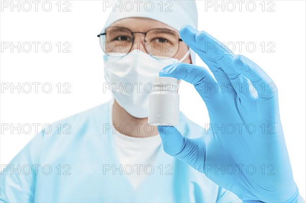 Portrait of a doctor with a jar of pill in hand. White background. Medicine concept.