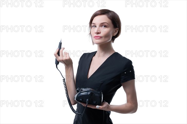 Portrait of a charming woman with a manicure device. Manicure and pedicure concept. Nails artist