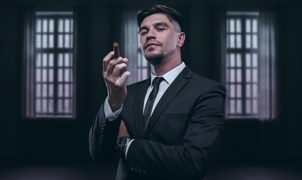 Portrait of a stylish man in a suit with a cigar. Business concept.