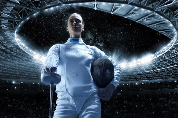 Young girl posing on a stadium background. The concept of fencing.