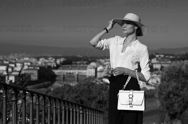 Portrait of a charming girl standing in a square in Florence. View of Santa Maria del Fiore. Tourism concept. Italy.