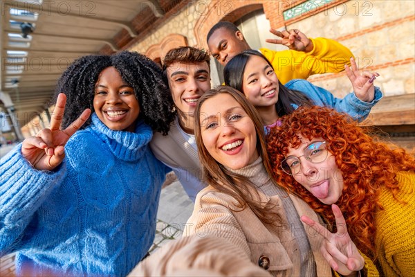 Friends pulling faces while taking a selfie in the city