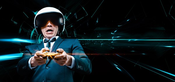 Portrait of a man in a suit and helmet of a pilot with a joystick in his hands. He enthusiastically plays a computer game. Game space. Game concept.