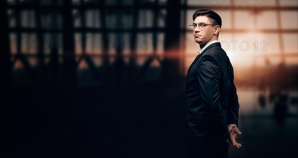 Portrait of a man in a business suit. He is standing at the airport and looking at the camera. Airline concept. VIP transportation. Private airlines. Charter flights.