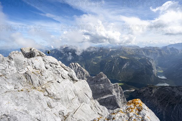 Mountaineer on the steep rocky summit of the Watzmann Mittelspitze