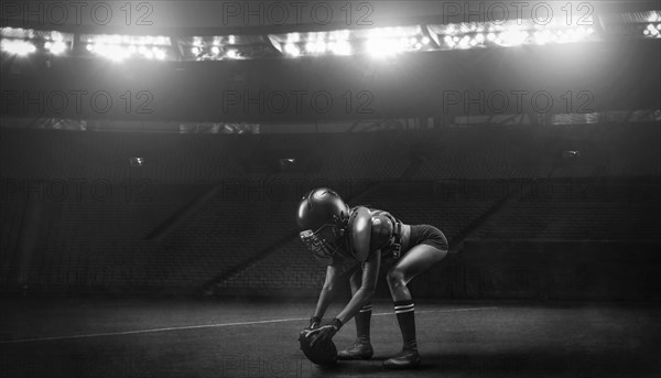 Image of a girl in the uniform of an American football team player preparing to play the ball at the stadium. Sports concept.