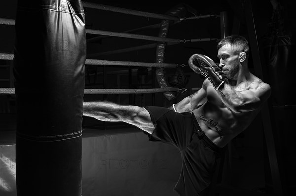 Kickboxer kicks the bag. Training a professional athlete. The concept of mma