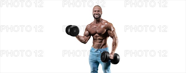 The athlete performs an exercise in the gym with dumbbells on a white background. Fitness