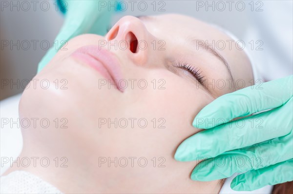 Beautiful girl gets face peeling. Skin health concept. Beauty salons.