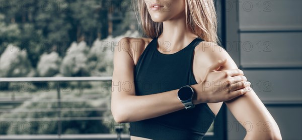 Charming girl posing with a smart watch. No name portrait. The concept of bodybuilding