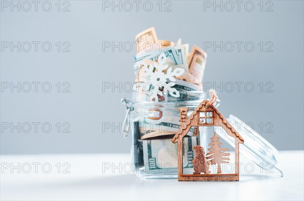 Glass piggy bank full of money. Christmas and New Year concept. Gift expenses.